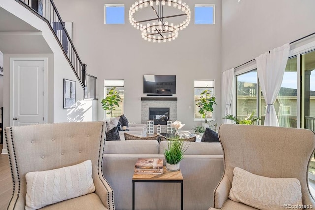 5390 Edenborn Way, Castle Rock, CO 80104 - living area featuring a chandelier, a high ceiling, and a stone fireplace