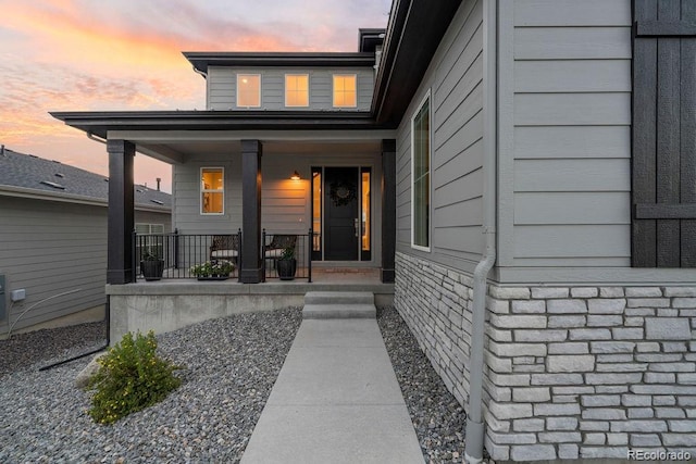 5390 Edenborn Way, Castle Rock, CO 80104 - exterior entry at dusk featuring a porch