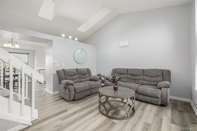 4512 Bramble Ln, Colorado Springs, CO 80925 - living room with a skylight, a chandelier, light wood finished floors, stairway, and lofted ceiling