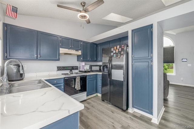 4512 Bramble Ln, Colorado Springs, CO 80925 - kitchen featuring refrigerator with ice dispenser, range with electric cooktop, under cabinet range hood, blue cabinetry, and ceiling fan