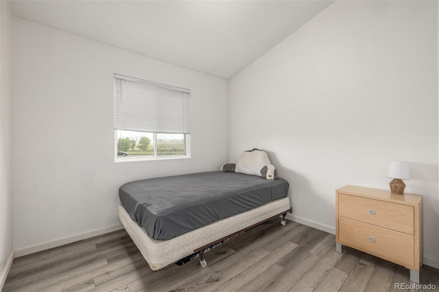 4512 Bramble Ln, Colorado Springs, CO 80925 - bedroom featuring wood finished floors and lofted ceiling