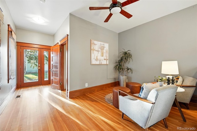 entrance foyer with visible vents, baseboards, light wood-style floors, and ceiling fan