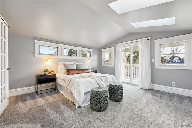 bedroom with baseboards, carpet floors, vaulted ceiling with skylight, and access to outside