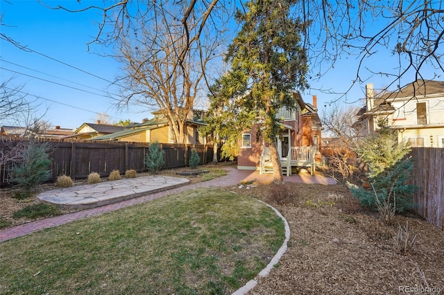 view of yard with a patio area and a fenced backyard