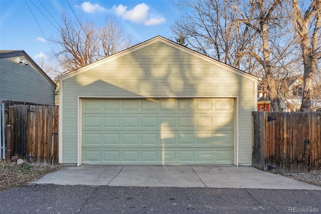 detached garage featuring fence