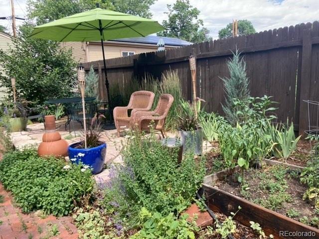 view of yard with a patio, a garden, and fence