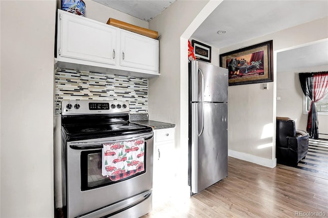 kitchen featuring light hardwood / wood-style floors, white cabinetry, appliances with stainless steel finishes, and tasteful backsplash