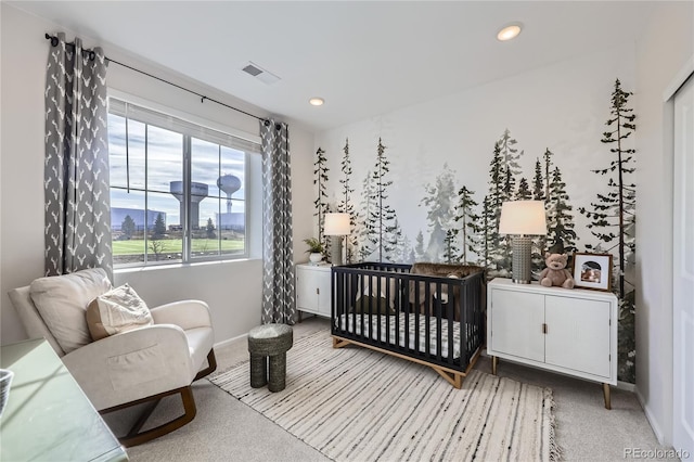 carpeted bedroom featuring baseboards, a crib, visible vents, and recessed lighting