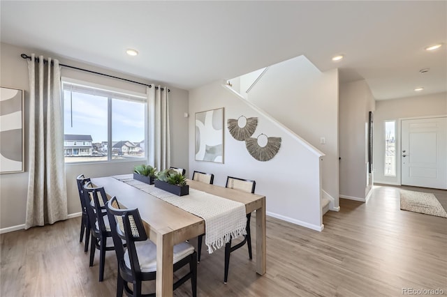 dining room with stairs, baseboards, wood finished floors, and recessed lighting