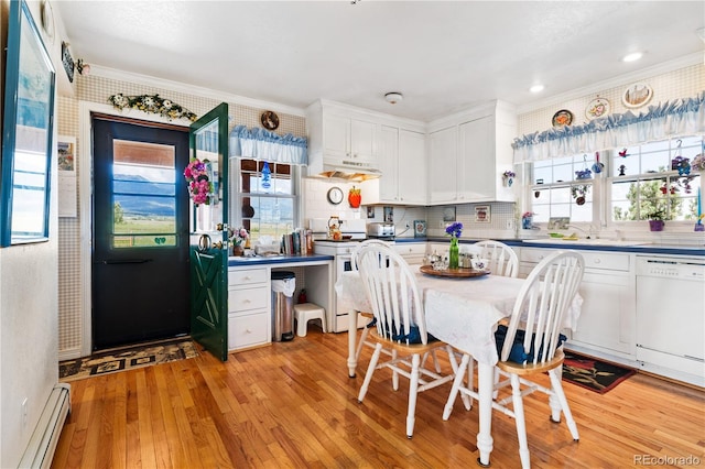 28 County Road 136, Westcliffe, CO 81252 - kitchen with light wood-style flooring, under cabinet range hood, white cabinetry, white appliances, and a baseboard radiator