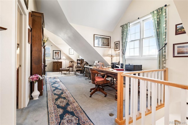 carpeted office space featuring vaulted ceiling