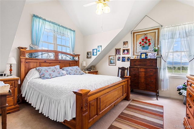 bedroom with ceiling fan, lofted ceiling, and light colored carpet