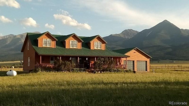 exterior space with a garage, a mountain view, and a rural view