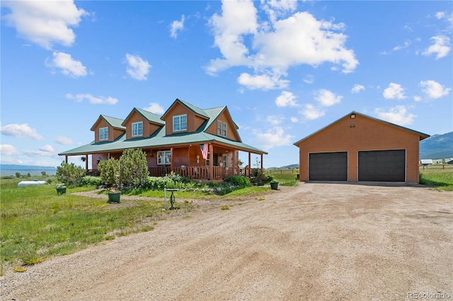 28 County Road 136, Westcliffe, CO 81252 - view of front of property with an outbuilding, a porch, metal roof, and a detached garage