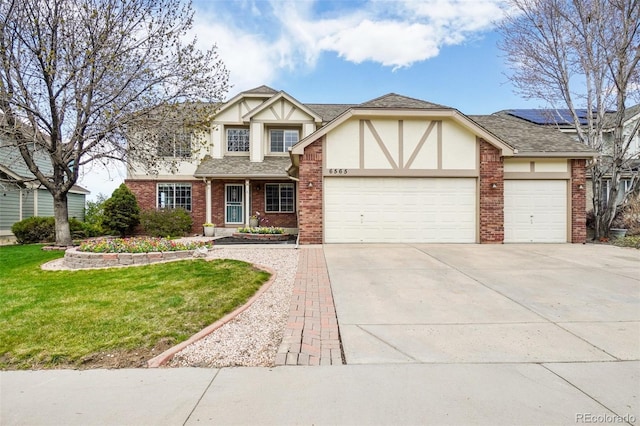 6565 W 99th Ave, Broomfield, CO 80021 - tudor home featuring a garage, a front yard, stucco siding, brick siding, and concrete driveway