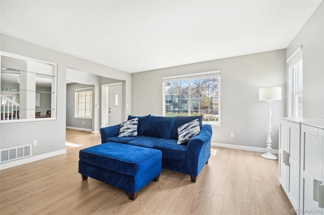 6565 W 99th Ave, Broomfield, CO 80021 - living area featuring baseboards, light wood finished floors, and visible vents