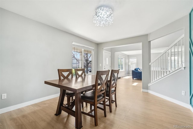 6565 W 99th Ave, Broomfield, CO 80021 - dining area with light wood-style floors, baseboards, stairs, and a chandelier