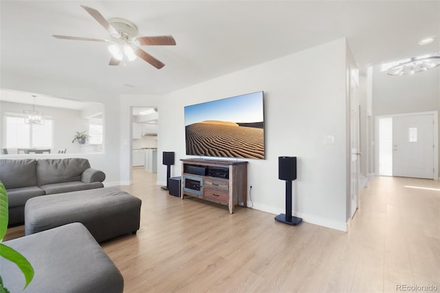 6565 W 99th Ave, Broomfield, CO 80021 - living area with baseboards, light wood-style flooring, and ceiling fan with notable chandelier