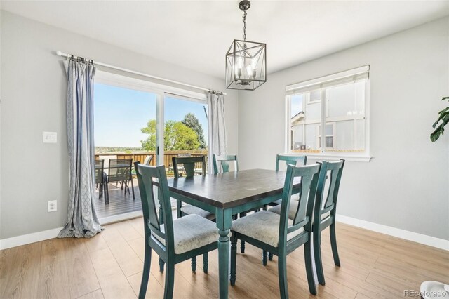 6565 W 99th Ave, Broomfield, CO 80021 - dining room featuring baseboards, a chandelier, and light wood-style floors
