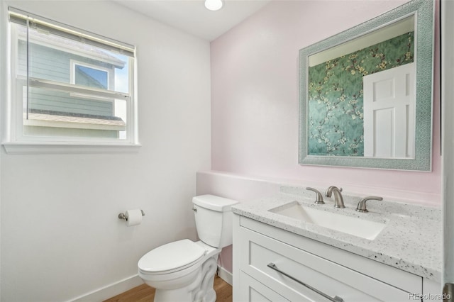6565 W 99th Ave, Broomfield, CO 80021 - half bath featuring toilet, baseboards, wood finished floors, and vanity