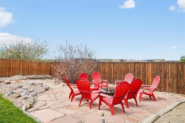 6565 W 99th Ave, Broomfield, CO 80021 - view of patio / terrace featuring a fenced backyard and an outdoor fire pit