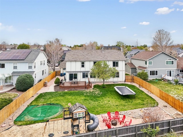 6565 W 99th Ave, Broomfield, CO 80021 - rear view of property featuring a wooden deck, a fenced backyard, a shingled roof, a lawn, and a residential view