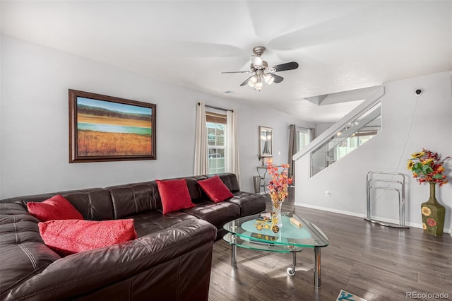 living room featuring ceiling fan and dark wood-type flooring