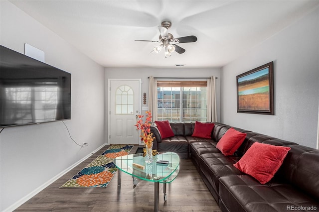 living room featuring ceiling fan and dark hardwood / wood-style flooring