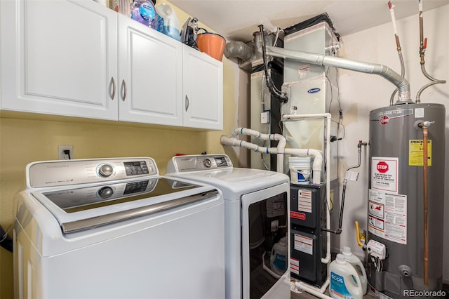 laundry area with washer and clothes dryer, cabinets, and gas water heater