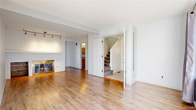 unfurnished living room with light hardwood / wood-style floors and a fireplace