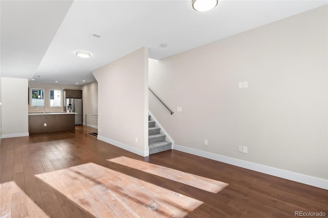 unfurnished living room featuring dark hardwood / wood-style floors