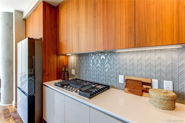 4200 W 17th Ave Unit 411, Denver, CO 80204 - kitchen featuring stainless steel gas cooktop, freestanding refrigerator, light countertops, and modern cabinets