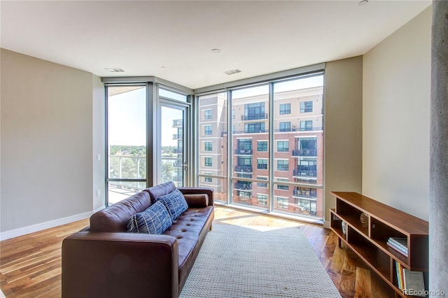 4200 W 17th Ave Unit 411, Denver, CO 80204 - living area featuring a wall of windows, plenty of natural light, and wood finished floors