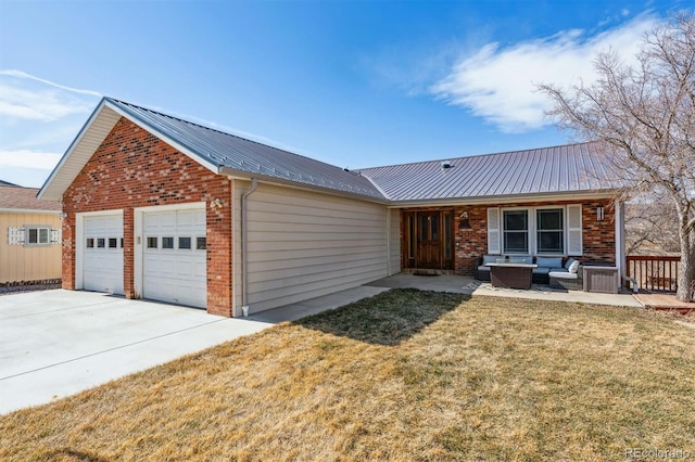 view of front of house with a garage, metal roof, a front lawn, outdoor lounge area, and brick siding