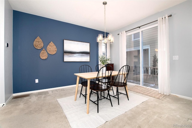 dining room with an inviting chandelier and carpet flooring