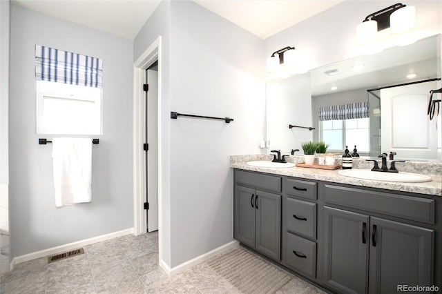 bathroom featuring tile patterned flooring and vanity