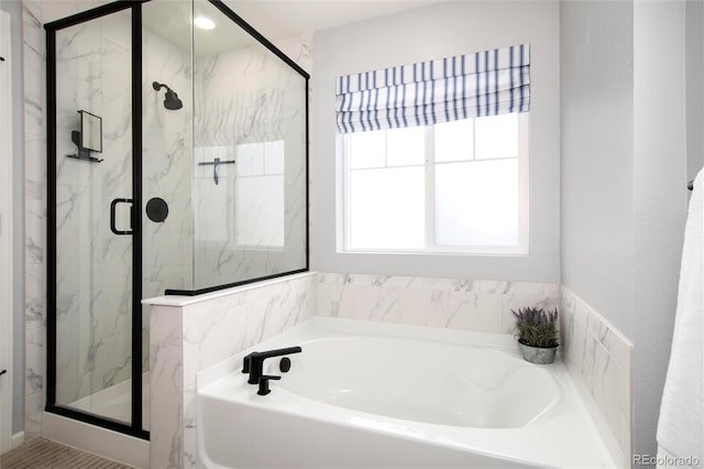 bathroom with shower with separate bathtub