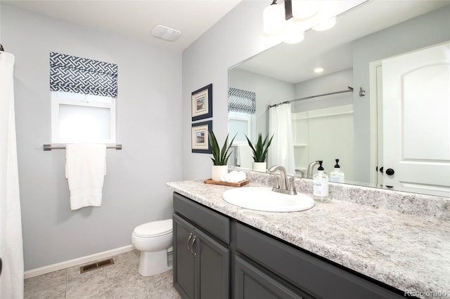 bathroom featuring toilet, vanity, and a shower with curtain