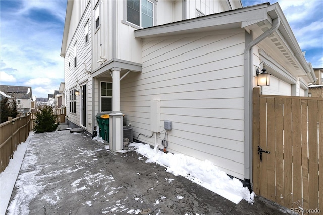 view of snowy exterior featuring cooling unit