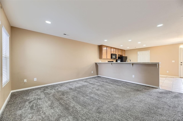 unfurnished living room featuring light carpet