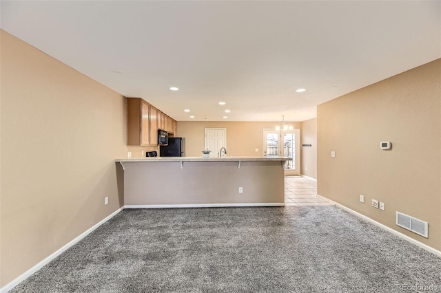 interior space featuring an inviting chandelier and light colored carpet