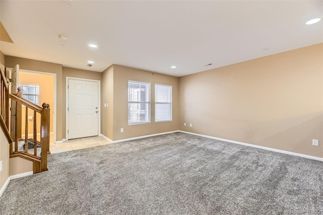 carpeted empty room with plenty of natural light