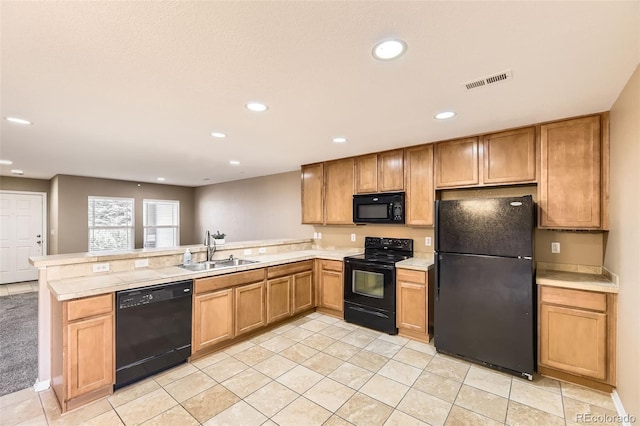 kitchen with sink, light tile patterned floors, black appliances, and kitchen peninsula