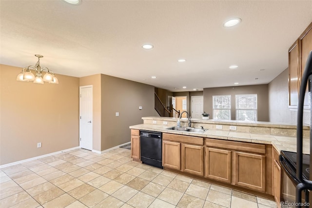 kitchen featuring hanging light fixtures, sink, light tile patterned floors, and black appliances