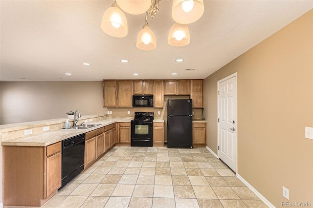 kitchen with pendant lighting, light tile patterned flooring, sink, and black appliances