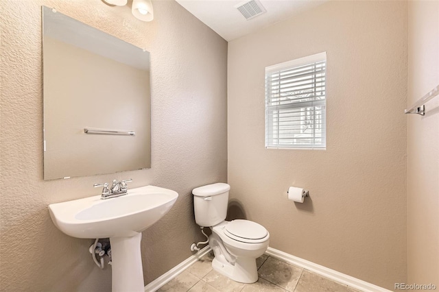 bathroom featuring tile patterned flooring and toilet