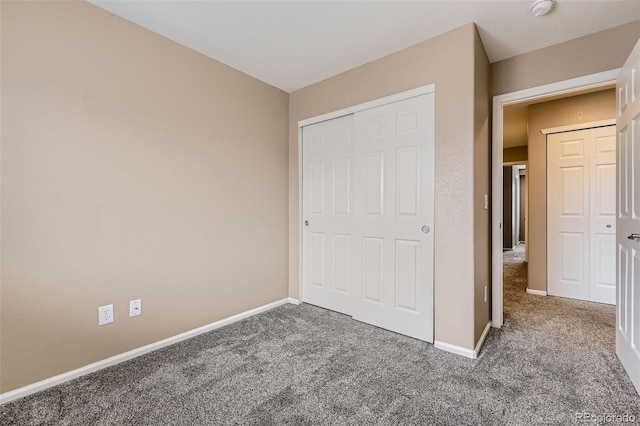 unfurnished bedroom with a closet and carpet