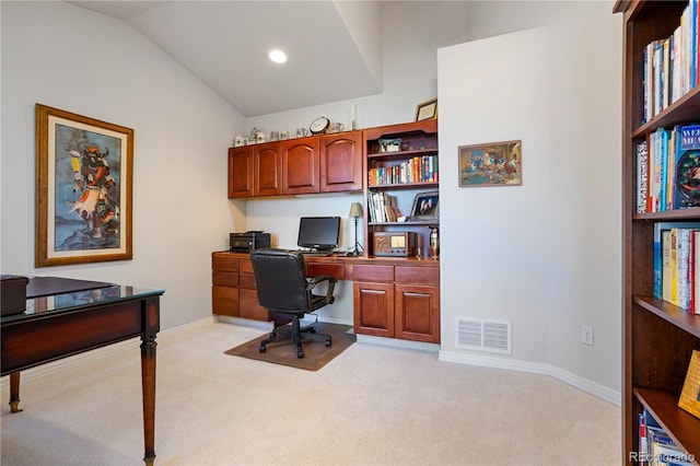 office with light carpet and lofted ceiling