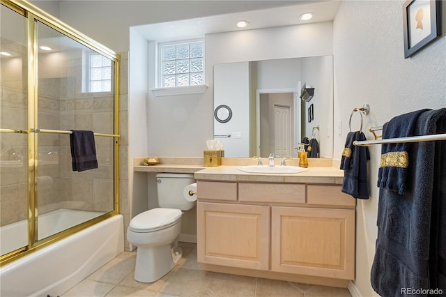 full bathroom with tile patterned flooring, vanity, combined bath / shower with glass door, and toilet