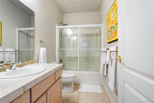 full bathroom with vanity, tile patterned floors, shower / bath combination with glass door, and toilet